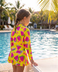 ZipMAE Swimwear Melon Mania swimsuit featuring vibrant melon print and slim fit design on a model.