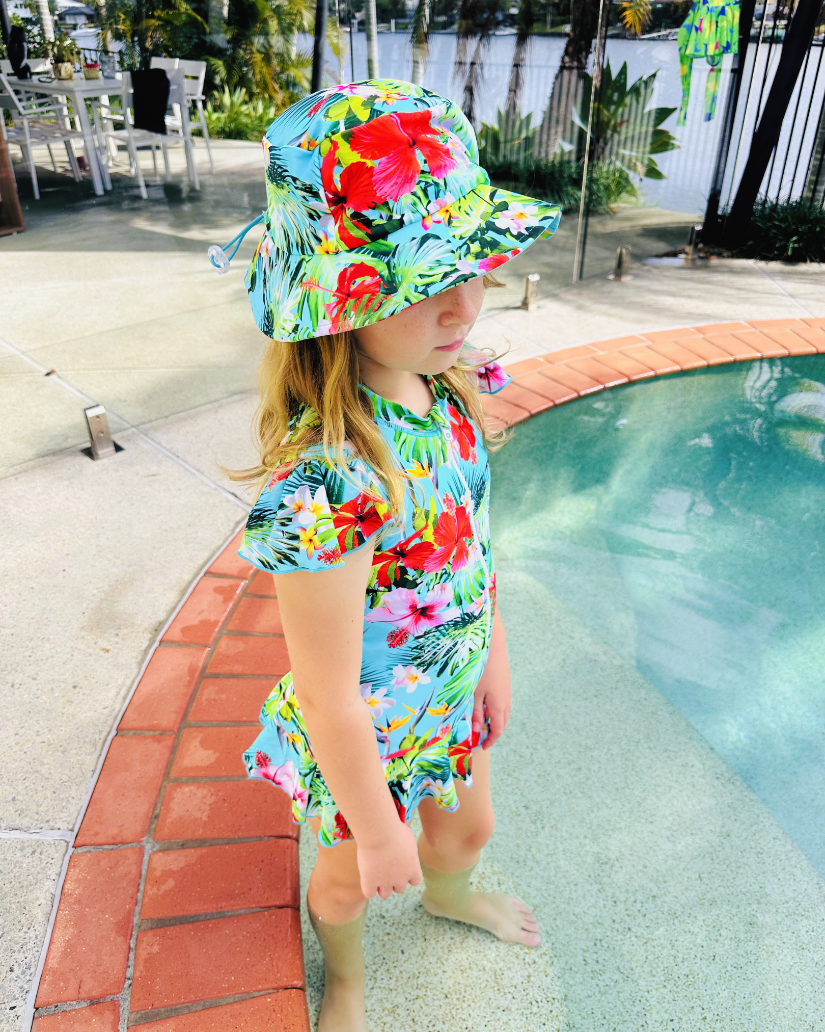 ZipMAE Swimwear Sun Hat Tropical Twist with wide brim and tropical print, perfect for sun protection and stylish beachwear.